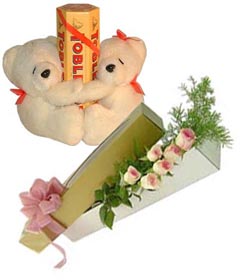 2 Teddys with 6 roses and tobler chocolates.