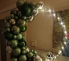 Transparent Balloon with fairy lights and arch of green cluster balloons