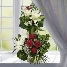 2 Feet tall arrangement of 6 Red Roses 6 White Lilies 6 white crysanthemums or gerberas and curled  draceana leaves