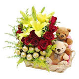 Basket of 4 lilies 12 red roses 16 ferrero chocolates and 2 teddy bears