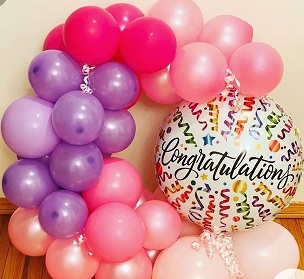 Clear congratulations printed Balloon encircled with multi colour balloons flowers and leaves