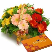 basket of flowers with chocolate celebration