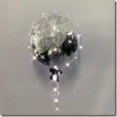 1 bubble transparent balloon with happy birthday print on balloon and balck silver balloons inside