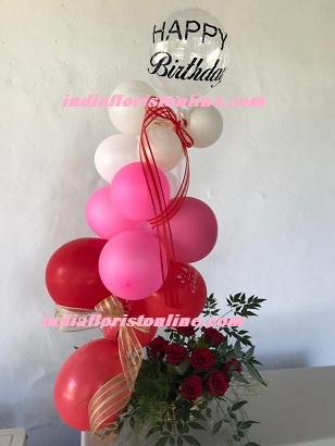 Pink red white balloons arrangement with roses and happy birthday balloon